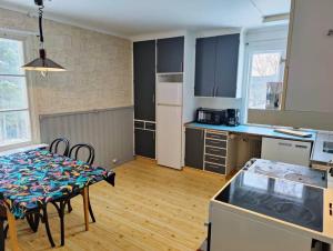 a kitchen with a table and a dining room at Mysigt hus med utsikt över fjäll och älv. in Järpen