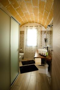 a bathroom with a sink and a toilet and a window at Casa Vacanza Patrizia in Marsala