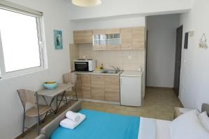 a small apartment with a kitchen and a table at Lilian's Seaview-Barstreet-Youth Studios in Rhodes Town