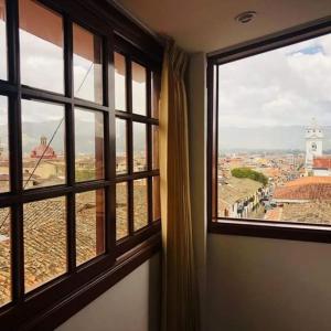 a room with a window with a view of a city at Hotel Silva Inn in Cajamarca