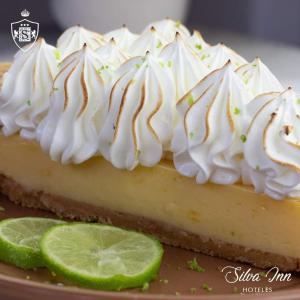 a lime cheesecake with whipped cream and a slice of lime at Hotel Silva Inn in Cajamarca