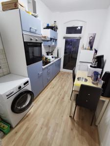 a kitchen with a washing machine and a table at NearWöhrderSeaAndStation in Nuremberg