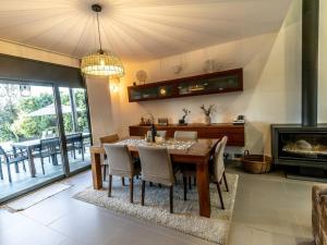 a dining room with a table and a fireplace at Montserrat Villa Deluxe Barcelona in Vacarisas
