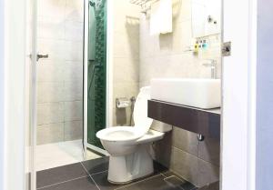 a bathroom with a toilet and a sink at Cenang Plaza Beach Hotel in Pantai Cenang