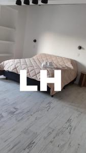 a bed in a room with white letters at Lujan Homes in Luján