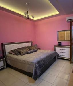 a bedroom with a bed in a pink wall at A&K Sea View Apartament 6 in Durrës