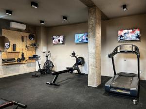 a gym with two treadmills and two exercise bikes at Hotel Mediteran in Zadar
