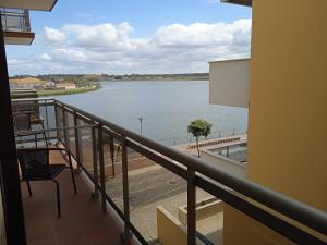 a balcony with a view of a body of water at Canadian Star in Praia de Mira