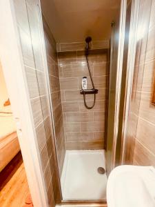 a bathroom with a shower with a toilet at White House Lodge in Cambridge