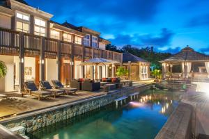 an exterior view of a house with a swimming pool at Villa L'Oasis in Oranjestad