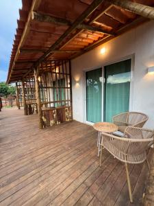 a patio with a table and chairs on a deck at Pousada do Nativo in Fernando de Noronha