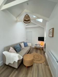 a living room with a couch and a table at Cosy country getaway, 5 mins from the sea in Penzance