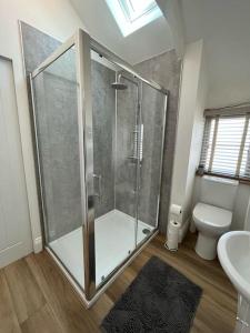 a bathroom with a shower and a toilet at Cosy country getaway, 5 mins from the sea in Penzance
