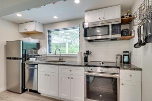 a kitchen with white cabinets and a stainless steel refrigerator at Round Rock Vacation Rental about 22 Mi to Dtwn Austin! in Round Rock