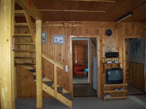 a log cabin with a staircase and a tv at Cabana Bavaria in Sovata