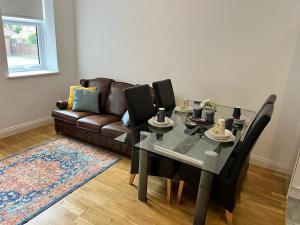 a living room with a table and a couch at Quiet, Private and Serene in Southend-on-Sea