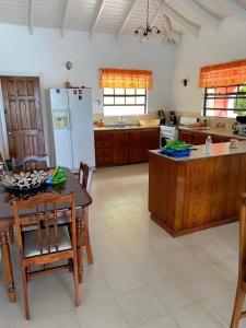 a large kitchen with a table and a refrigerator at The View Villa in Port Elizabeth