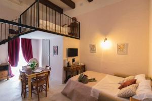 a living room with a bed and a staircase at Casa Ricca in St Paul's Bay