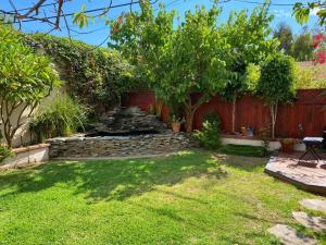 a backyard with a stone path and trees and a fence at 3 Bd Beverly Hills House in Los Angeles