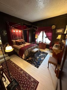a bedroom with a canopy bed and a rug at Inn of Glen Haven in Glen Haven