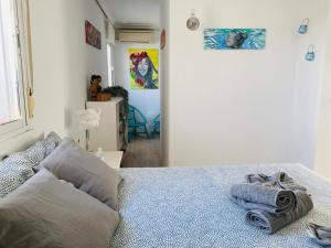a bedroom with a bed with towels on it at Ático Cádiz Playa in Cádiz