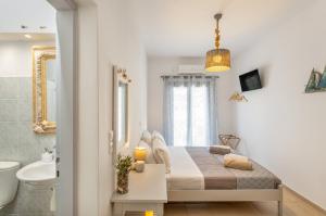 a bedroom with a bed and a bathroom at Yialos Rooms in Piso Livadi