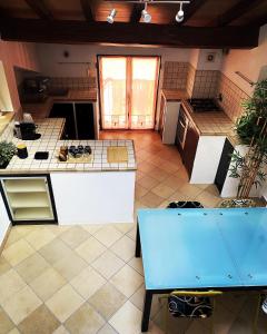 a large kitchen with a counter top in a room at Civico 18 B&B in Montecchio Emilia