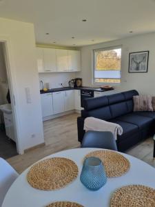 a living room with a couch and a table at Ferienhaus Diemelaue in Bad Karlshafen