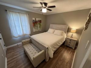 a bedroom with a bed and a ceiling fan at Spacious 3 bedroom home near Amphitheater/Baseball/shopping and much more in Pearl