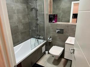 a bathroom with a tub and a toilet and a shower at Quiet, Private and Serene in Southend-on-Sea