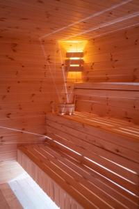 an empty wooden sauna with a light in it at Anielski Zakątek Solina in Solina