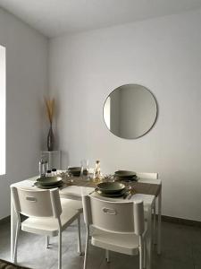 comedor con mesa con sillas y espejo en Appartement Les Halles Narbonne en Narbonne