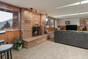 a living room with a fireplace and a couch at Spacious Colorado Retreat with Deck and Mountain Views in Estes Park