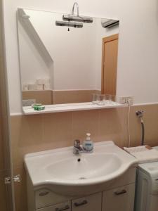 a bathroom with a sink and a mirror at Apartment Duncovich in Cres