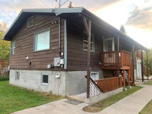 a house with a porch and a deck on it at Newly Remodeled Relaxing Stay near Downtown in Fairbanks