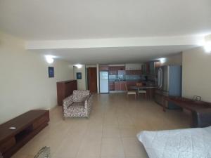 a large living room with a couch and a kitchen at Beach View Palace in Porlamar