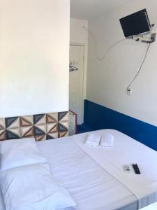 En eller flere senge i et værelse på Tia Preta Pousada