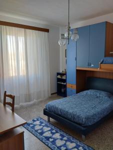a bedroom with a bed and a table and a desk at Casa Graziella in Cecina