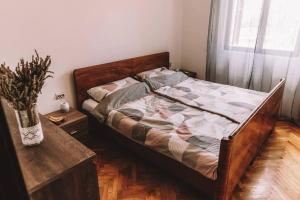 a bed in a bedroom with a vase on a table at Holiday house Zlata in Banjol