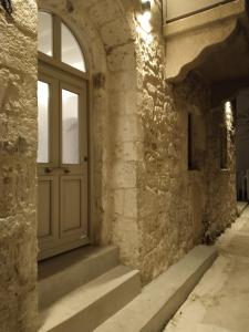 an entrance to a stone building with a door and stairs at Oniropagida Nisyros apartment #1 in Nikiá