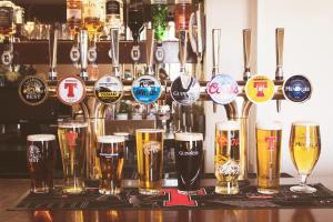 a bar with a bunch of glasses of beer at THE EARN HOTEL in Bridge of Earn