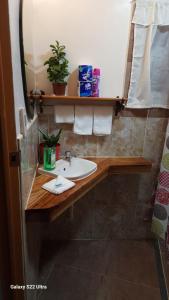 a bathroom with a sink and a mirror at Chue&larry's Beachside Homestay in Libagon