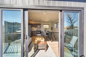 een glazen schuifdeur naar een balkon bij Modern Erie Home - Walk to Downtown! in Erie