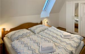 a bedroom with a bed with two towels on it at Cozy Apartment In Axams With Kitchen in Innsbruck