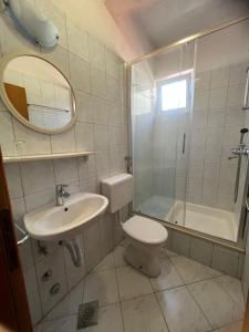 a bathroom with a toilet and a sink and a shower at Apartments Jurisic in Baška Voda