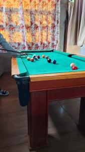 a pool table with balls on top of it at Residencial Saldanha in Gramado