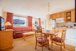 a kitchen and a living room with a table and chairs at Heidelberg Inn & Resort in June Lake