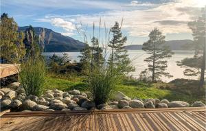 a garden with rocks and a view of a lake at 5 Bedroom Gorgeous Home In Vikedal in Vikedal