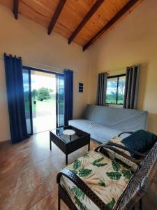 a bedroom with a bed and a table and windows at Resort Sport in Independencia