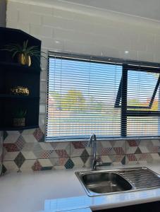 a kitchen counter with a sink and a window at Modern studio apartments in Secunda +25 photos
